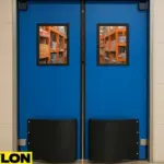 Blue double swinging door with reinforced kick plates and vision panels, designed for high-impact environments with frequent cart or forklift traffic, illustrating durability and abuse resistance