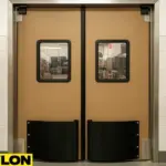 A pair of PE-9000 industrial double-swinging doors installed in a butcher shop setting, designed for high-impact traffic and easy sanitation in meat processing environments