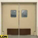 A pair of beige PEX-9000 industrial double-swing doors in a clean, food-safe environment, featuring rectangular vision panels and lower impact plates for durability in high-traffic areas