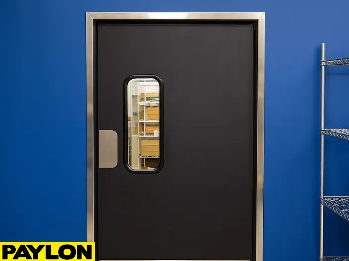 Closed single-panel PE-710 retail swinging door in a store stockroom Closed single-panel PE-710 retail swinging door in a store stockroom, designed for light-duty use with narrow frame and clear vision window