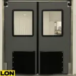Industrial Door PE-1500 installed in a clean food processing environment, featuring stainless steel framing, protective kickplates, and seamless wall panels for hygienic operation