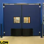 Industrial Door PE-9000 by Paylon – Durable Blue Swinging Doors with Black Lower Impact Plates and Vision Windows for Warehouse or Storage Facilities