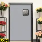 Retail Door PE-710 in a florist shop, featuring a sleek gray design with a small window, framed by vibrant flower arrangements in metal buckets on black shelving units