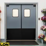 Retail Door PE-720 installed in a florist shop, surrounded by metal buckets filled with colorful fresh flowers on both sides