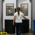 Worker entering a food processing facility through an Industrial Door PE-1500, showcasing its clean design, hands-free access, and suitability for hygienic environments
