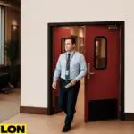 Airport staff member exiting through Industrial Door PE-8000 in airport lounge staff access area