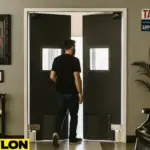 Industrial Door | PE-8000 swinging door in a tattoo parlor, providing easy room access while maintaining client privacy, with tattoo artwork, décor, and a client walking through the studio