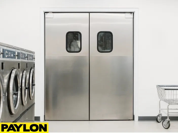 Retail Door PE-620ALC installed in a commercial laundromat, providing secure and discreet access to backroom areas while maintaining a clean, professional look