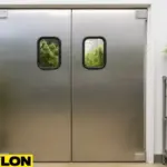 Retail Door PE-620ALC swinging door installed in an indoor grow operation, with cannabis plants and greenhouse equipment visible through the windows