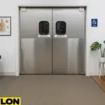 Retail Door PE-620ALC swinging doors installed in a chiropractic and massage clinic, showing a professional, clean interior with treatment tables, anatomical charts, and a calming plant, highlighting the door’s durability and modern design