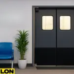 Retail Door PE-720 installed in an airport lounge staff access area with signage reading ‘Airport Lounges Staff Access Only,’ blue waiting chairs, and a potted plant on the side.