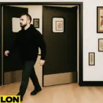 Industrial Door | PE-8000 swinging door in a tattoo parlor, providing easy room access while maintaining client privacy, with tattoo artwork, décor, and a client walking through the studio