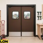 Retail Door PE-720 swinging door installed in a tool rental shop, shown with shelves of hard hats, power tools, and a clear view of construction equipment in the outdoor yard