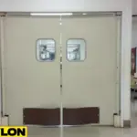 Beige PE-Series Factory Break Room Doors connecting a cafeteria to the factory workspace for easy access