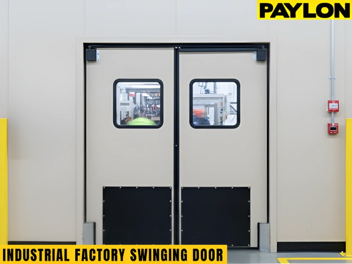 Beige industrial factory swinging doors designed for high-traffic production areas and equipment movement.