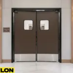 Brown double swinging door with stainless kick plates in a hospitality corridor, blending durability and design
