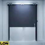 Closed black insulated cold storage sliding door with aluminum diamond plate bottom panel for impact protection