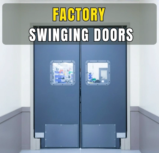 Closed double swinging factory doors with impact-resistant panels and clear vision windows in a clean industrial hallway