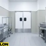 Commercial Kitchen Door Closed – White double swinging kitchen doors closed in a large professional kitchen corridor