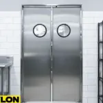 Double stainless steel swinging doors with round vision panels separating food prep and service zones