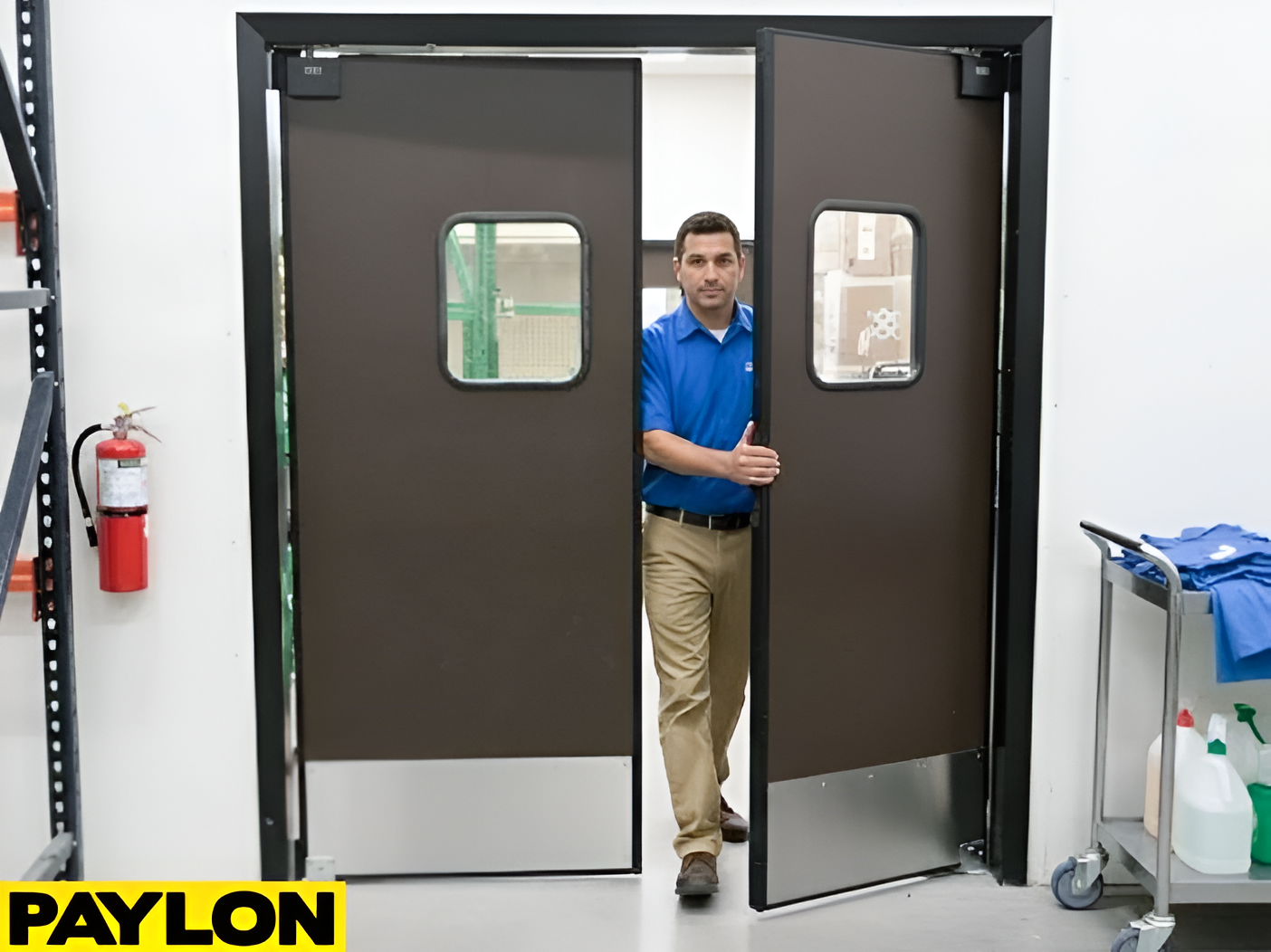 Employee walking through double swinging doors in a retail backroom with dark brown panels and vision window
