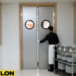 Gray Banquet Hall Swinging Door with Server – Front view of a gray Banquet Hall Swinging Door in a hallway with a server moving a dish cart. Gray Banquet Hall Swinging Door with Server – Front view of a gray Banquet Hall Swinging Door in a hallway with a server moving a dish cart.
