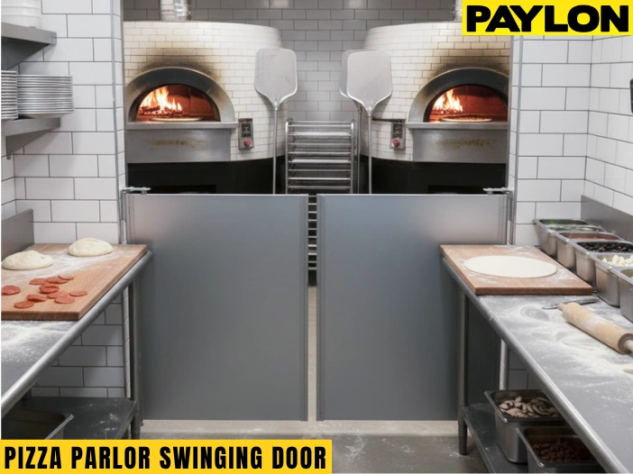 Gray café-style pizza parlor swinging doors installed in a dual-oven pizzeria kitchen with dough and ingredients on prep counters Gray café-style pizza parlor swinging doors installed in a dual-oven pizzeria kitchen with dough and ingredients on prep counters
