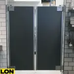 Gray double-action restaurant kitchen door installed between prep stations Gray double-action restaurant kitchen door installed between prep stations