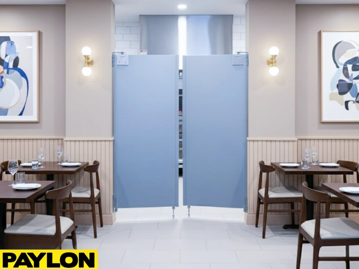 Gray restaurant café doors separating dining area and kitchen, maintaining workflow and safety Gray restaurant café doors separating dining area and kitchen, maintaining workflow and safety