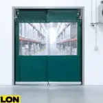 Green PVC swinging doors with clear vision panels in a cold storage facility Green PVC swinging doors with clear vision panels in a cold storage facility