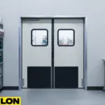 Grey double-swing warehouse impact door with clear vision panels in production facility Grey double-swing warehouse impact door with clear vision panels in production facility