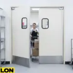 Kitchen Staff with Cart – White swinging kitchen door open with staff pushing a cart in a commercial prep area