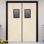 Light wood-colored PE-Series kitchen swinging traffic doors with rectangular windows in a commercial kitchen