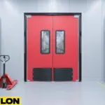 Red double swinging factory doors with clear windows installed in a warehouse loading zone Red double swinging factory doors with clear windows installed in a warehouse loading zone