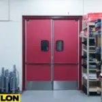 Red high-pressure laminate swinging doors with stainless kick plates in a storage area, built for heavy-use commercial kitchen environments