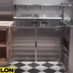 Stainless steel café doors installed in a modern restaurant with table seating and minimal décor Stainless steel café doors installed in a modern restaurant with table seating and minimal décor