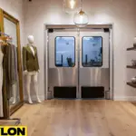 Stainless steel double swinging doors in a boutique or retail shop, combining modern look with functionality