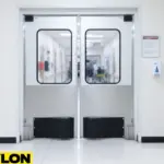 Stainless steel impact swinging doors with clear panels in a hospital corridor