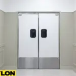 White Banquet Hall Swinging Door – Commercial white Banquet Hall Swinging Door with stainless kick plates in a neutral corridor White Banquet Hall Swinging Door – Commercial white Banquet Hall Swinging Door with stainless kick plates in a neutral corridor