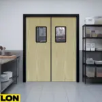 Wood-Style Swinging Kitchen Door – Light wood grain swinging kitchen door with vision panels in a commercial kitchen