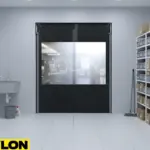 Black Impact Swinging Door with clear vision panel separating storage and prep areas in a facility