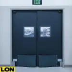 Black double industrial impact doors with vision panels in production facility