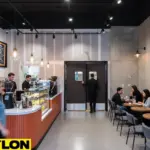 Café with red swinging doors and staff serving customers at front counter