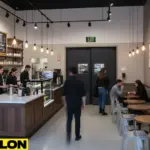 Coffee shop prep and service area showing staff moving through double-swing door