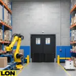 Heavy-duty black industrial double doors by Paylon in an automated warehouse with robotic equipment
