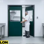Paylon green double action swing doors in a commercial kitchen, designed for hygiene control and easy hands-free movement