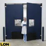 Paylon industrial double doors in a cleanroom facility with staff member exiting through insulated panels