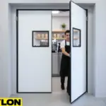 Paylon white double action swing door in a café prep area, allowing smooth two-way access for staff and equipment