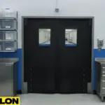 Black medical lab swinging door designed for sanitation-friendly use in controlled lab and processing areas.