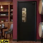 Black swinging door with a slim vision panel separating a winery tasting room from the backroom storage area.